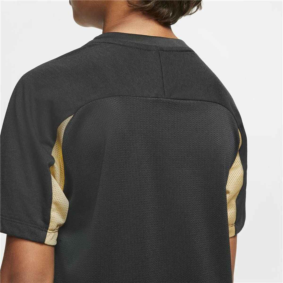 Back view of a person wearing a black and beige sports jersey with mesh fabric