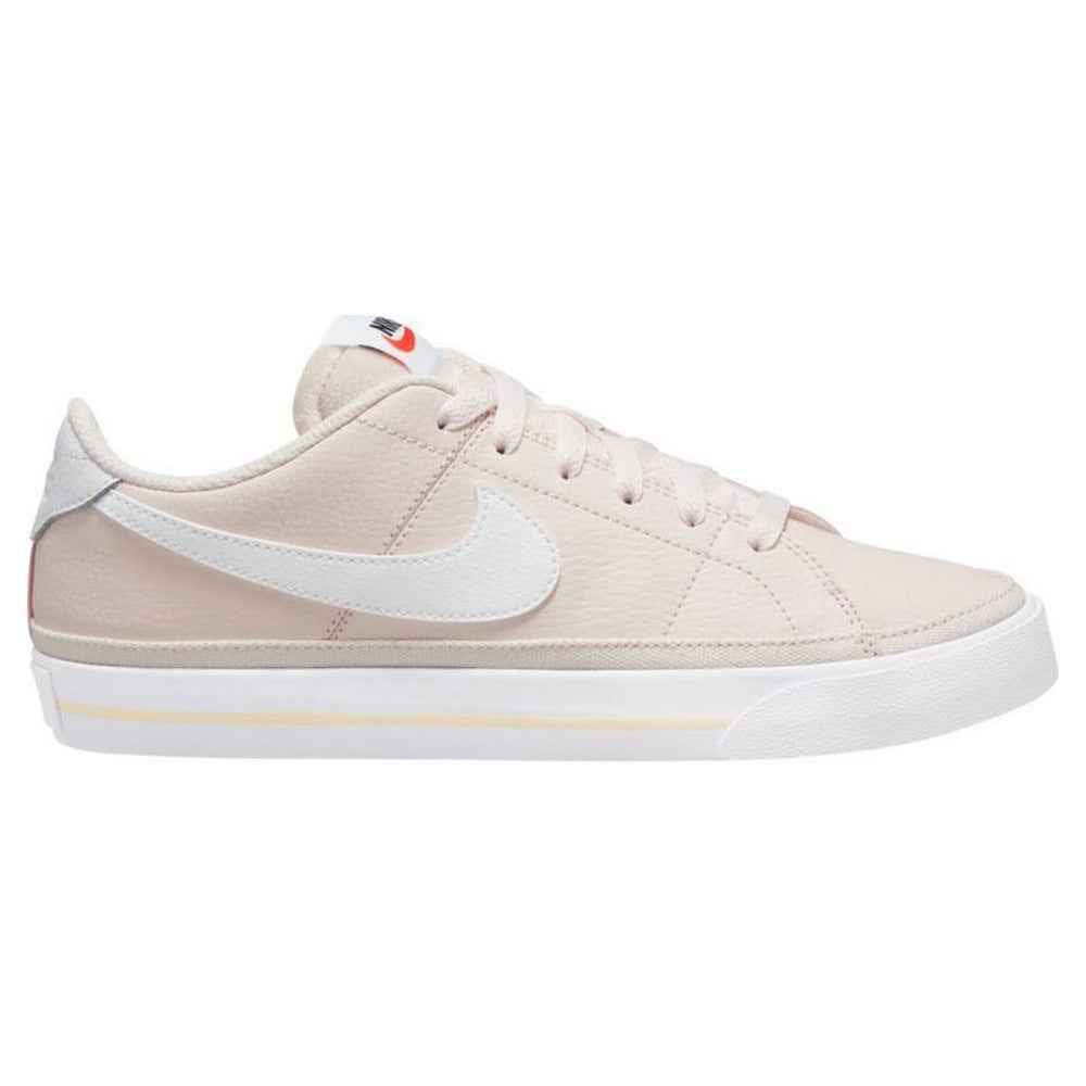 Nike Court Legacy W trainers in pale pink with white swoosh and light sole.