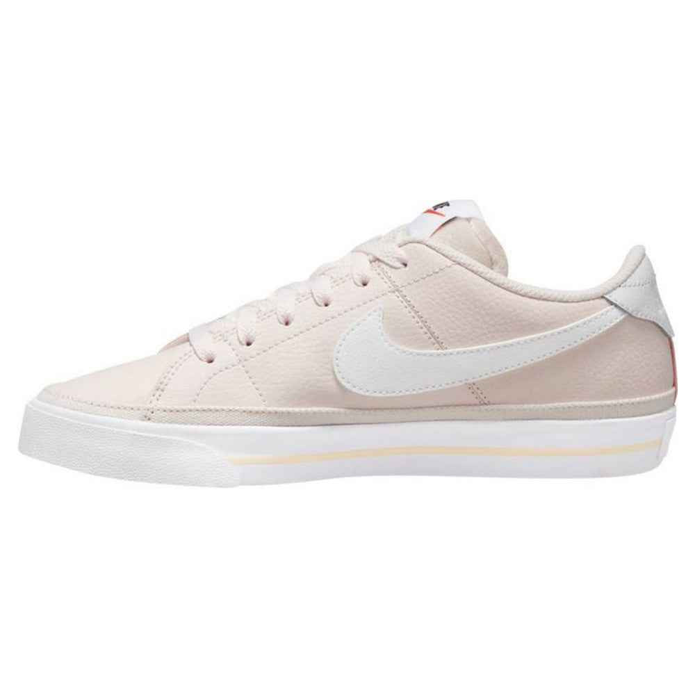Nike Court Legacy W trainers in pale pink with white swoosh, women's sneakers.