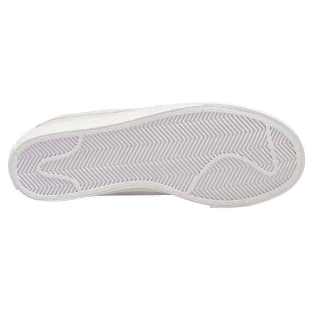 Outsole view of white Nike Court Legacy W trainer with herringbone tread.