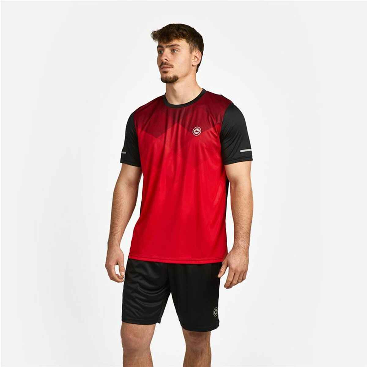 Man wearing red and black athletic t-shirt with matching black shorts on white background
